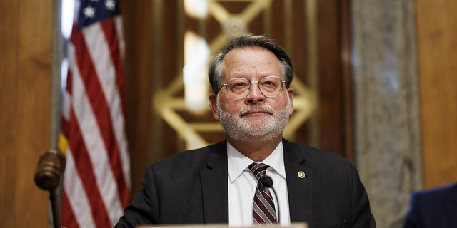 Sen. Gary Peters, a Democrat from Michigan and chairman of the Senate Homeland Security and Governmental Affairs Committee, gavels in during a hearing in Washington, D.C., US, on Nov. 17, 2022.