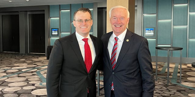 Former Republican Gov. Asa Hutchinson of Arkansas (right) teams up with newly inaugurated Iowa Lt. Gov. Adam Gregg, on Friday Jan. 13, 2023 in Des Moines, Iowa.