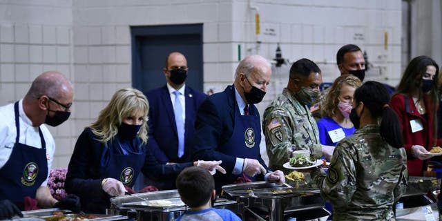 President Joe Biden and Jill Biden serve food to soldiers and their families at Fort Bragg.