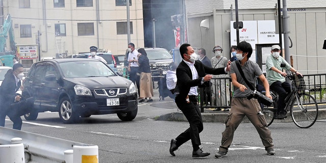 A police officer detains a man, believed to have shot former Japanese Prime Minister Shinzo Abe, in Nara, western Japan July 8, 2022.