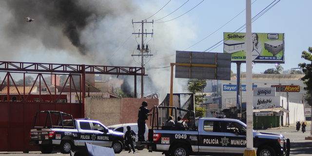 Police arrive on scene after a store was looted in Culiacan on Thursday, Jan. 5.