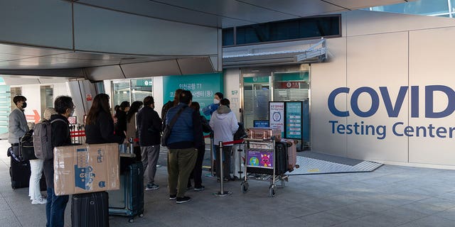 Starting early January, travelers arriving from China would need to submit a negative result from a rapid antigen test taken within 24 hours or a PCR test no more than 48 hours before departure. They also must undergo another PCR test upon arrival. Pictured: Passengers queue in line at a COVID testing center in Incheon International Airport, South Korea, on Dec. 3, 2021.