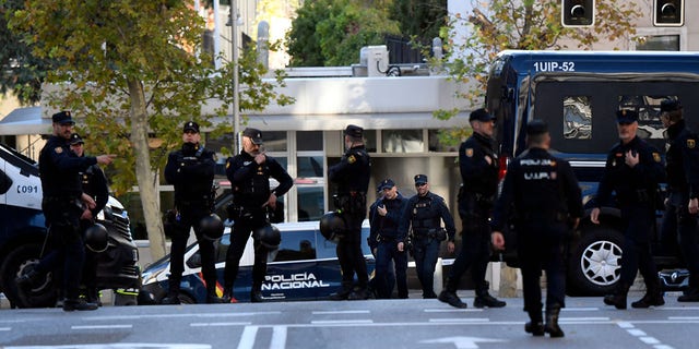 Spanish police stand guard near the US embassy in Madrid, on December 1, 2022, after they have received a letter bomb, similar to one which went off at the Ukrainian embassy. 