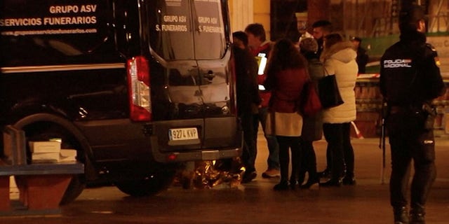 People gather next to a funeral vehicle at the scene of a stabbing incident at a church in Algeciras, Spain January 25, 2023 in this screen grab from a video.