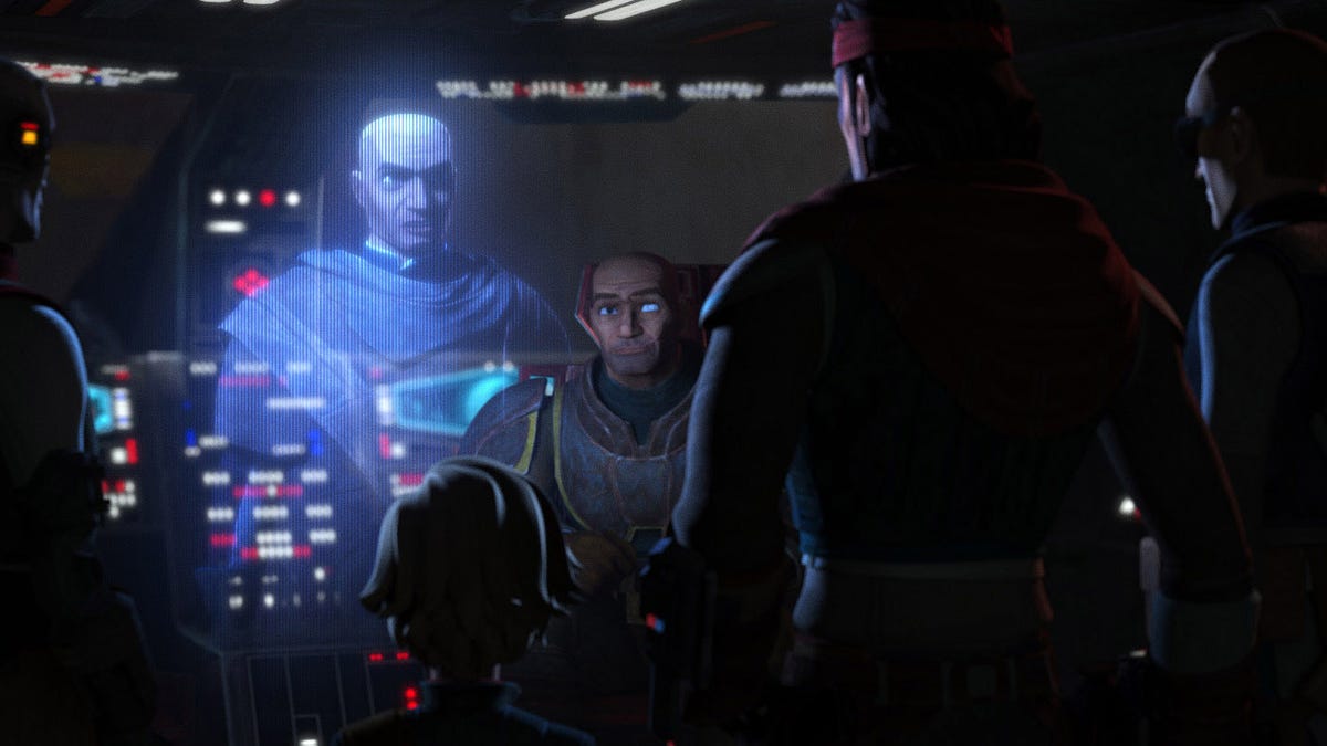 A holographic Rex addresses the Bad Batch in a dimly lit cockpit.