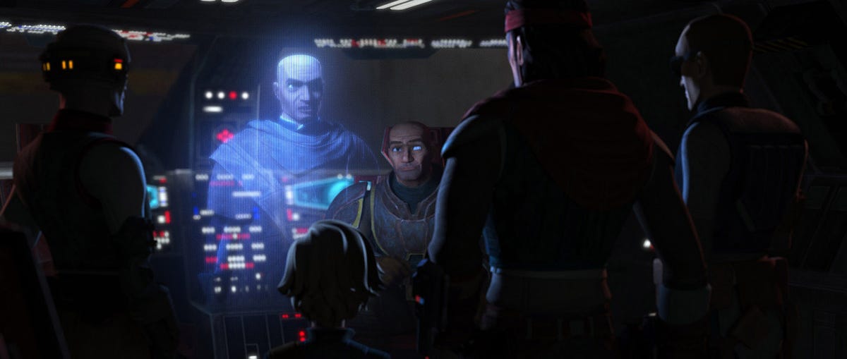 A holographic Rex addresses the Bad Batch in a dimly lit cockpit.