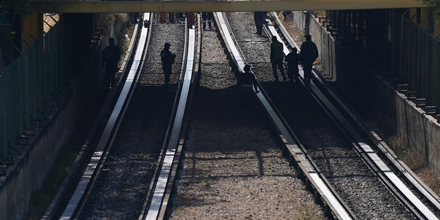 Rescue workers inspect rail lines after two subway trains collided, in Mexico City, Saturday, Jan. 7, 2023. Authorities announced at least one person was killed and dozens were injured in the Saturday accident on Line 3 of the capital's subway. 