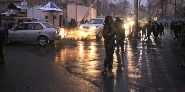 Police take security measures after casualties were feared after a huge explosion and gunfire were reported outside Afghanistan's Foreign Ministry building.
