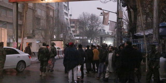 Police take security measures after casualties were feared after a huge explosion and gunfire were reported outside Afghanistan's Foreign Ministry building.