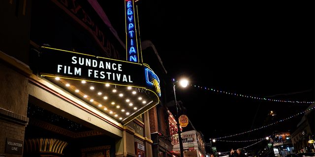 Pedestrians take photos of the marquee of the Egyptian Theatre before the 2023 Sundance Film Festival, Wednesday, Jan. 18, 2023, in Park City, Utah.