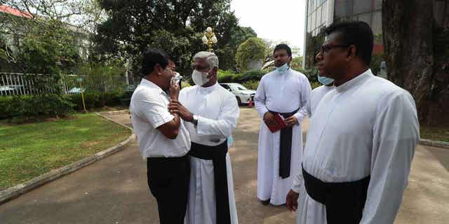 A Catholic priest stands with a family member of one of the deceased after Sri Lanka’s Supreme Court pronounced judgment on the 2019 Easter Sunday bomb attacks in Colombo, Sri Lanka, on Jan. 12, 2023. Sri Lanka’s Supreme Court ruled that inaction by the country's former president and other officials led to the attacks that killed nearly 270 people.