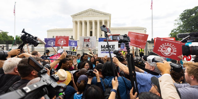 Crowds outside the Supreme Court react to the Dobbs ruling.