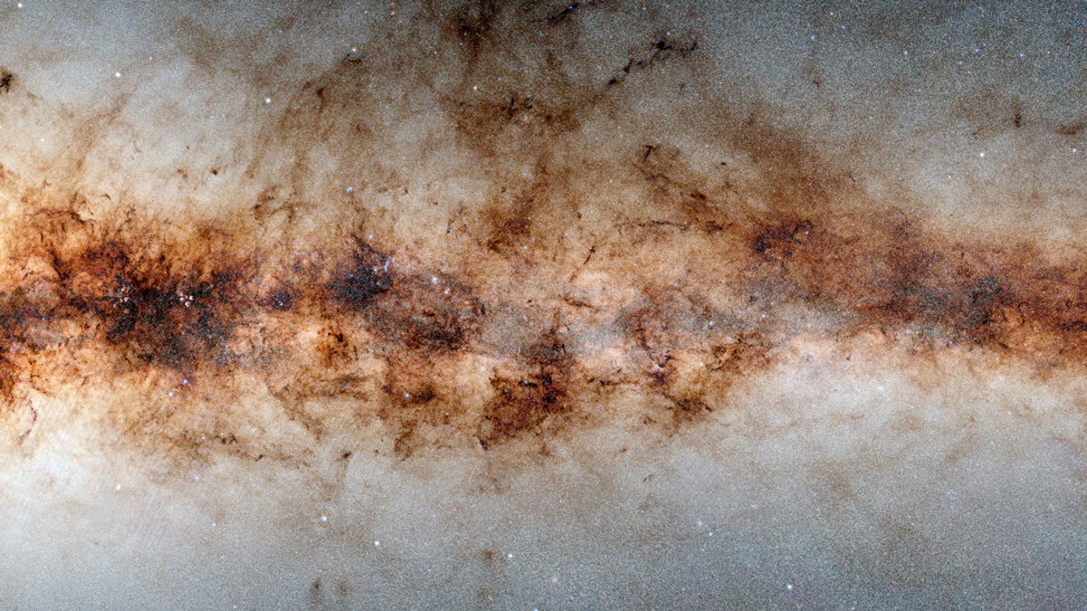 Cropped portion of part of the Milky Way shows thousands and thousands of stars and celestial objects. If looks like a strange, spangly cloud in shades of brown and beige.