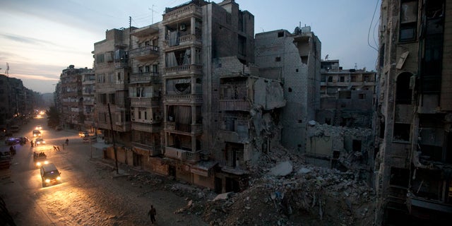 Nov. 29, 2012: Night falls on a Syrian rebel-controlled area of Aleppo as destroyed buildings, including Dar Al-Shifa hospital, are seen on Sa'ar street after airstrikes targeted the area a week before.
