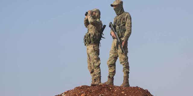 Turkey-backed Syrian fighters are shown manning positions on Dec. 2, 2022. The Syrian Kurdish-led forces captured a militant who served as the chief of the Islamic State group in Ragga.