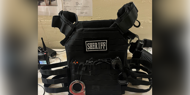 At the time of his arrest, Jones was wearing a ballistic vest with a "Sheriff" patch on it and a duty belt with knives, a flashlight, and handcuffs.