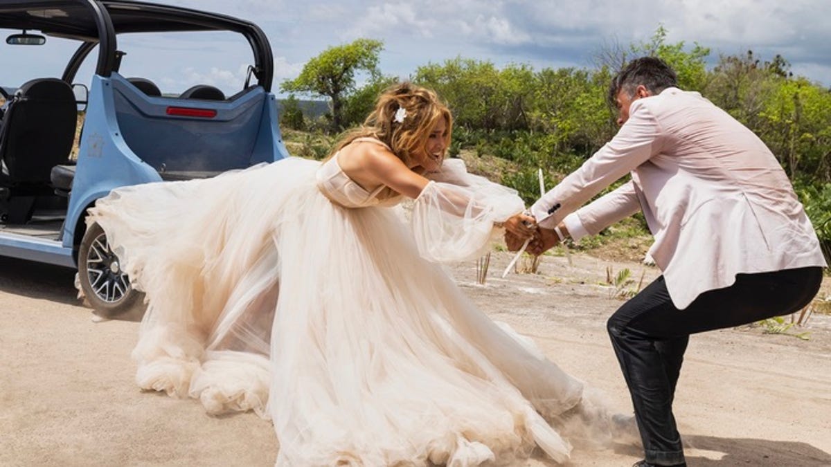 Jennifer Lopez and Josh Duhamel's hands are tied together in an image from Shotgun Wedding.