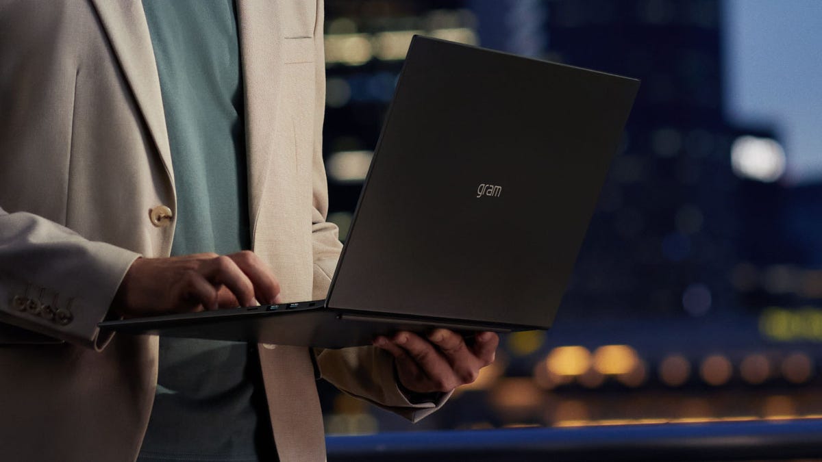 LG Gram laptop being held in someone's hands.