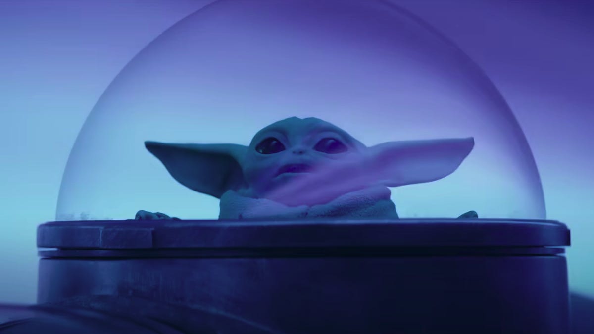Grogu gazes out of a bubble viewport as his ship travels through hyperspace in The Mandalorian season 3