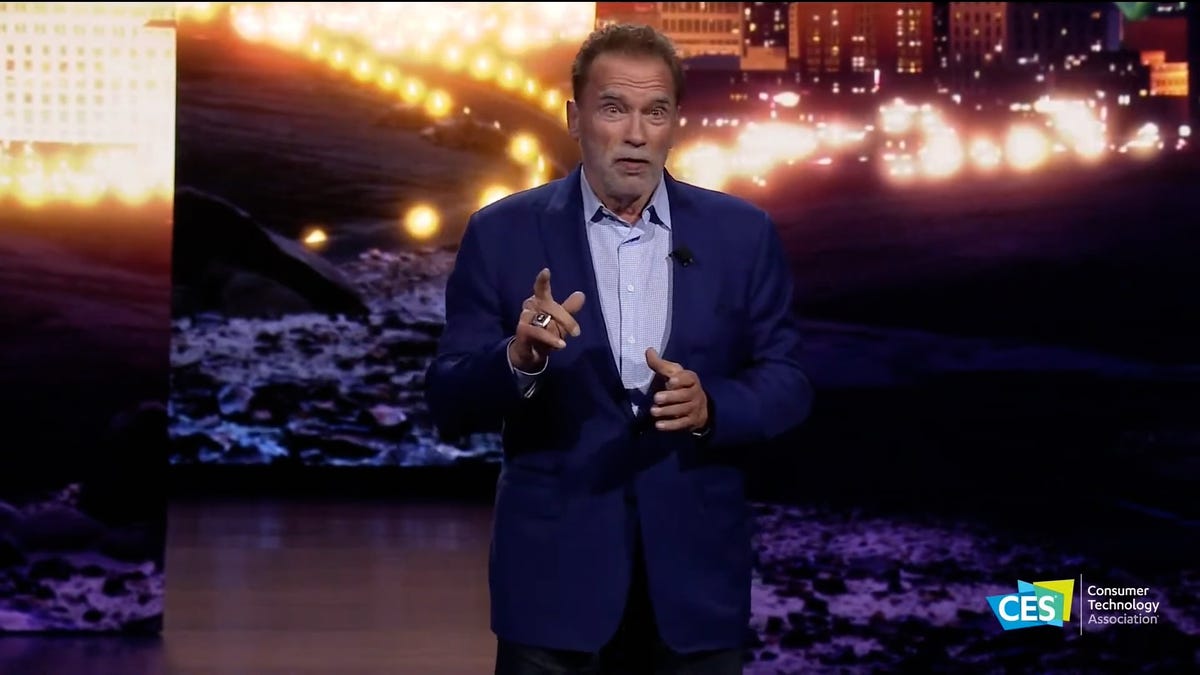 Schwarzenegger gestures while speaking.