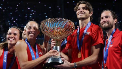 Team USA celebrate with the trophy. 