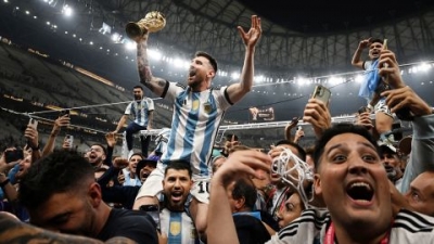 Lionel Messi celebrates with fans and teammates after winning the World Cup in Qatar.