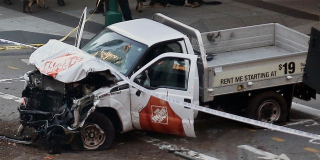 Police tape rests on a damaged Home Depot truck sits after a motorist drove onto a bike path near the World Trade Center memorial, striking and killing several people Tuesday, Oct. 31, 2017, in New York. (AP Photo/Bebeto Matthews)