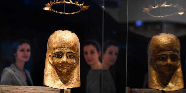 Museum staff view the Mummy Mask of Monstuef and the Wreath of Monstuef at the National Museums Scotland in Edinburgh.