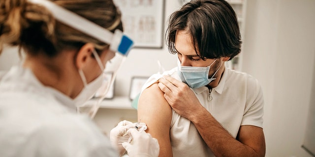 Medical doctor giving injection to make antibody for coronavirus