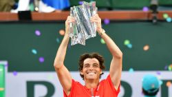 Taylor Fritz of the US hoists the championship trophy after defeating Rafael Nadal of Spain in their ATP Men's Final at the Indian Wells tennis tournament on March 20, 2022 in Indian Wells, California. - Taylor Fritz stunned Rafael Nadal 6-3, 7-6 (7/5) on Sunday to win the ATP Indian Wells Masters and end the 21-time Grand Slam champion's perfect 20-0 run to start 2022.
Fritz, ranked 20th in the world, claimed his second career title and his first at the elite Masters 1000 level while denying Nadal a record-equalling 37th Masters crown. (Photo by Frederic J. BROWN / AFP) (Photo by FREDERIC J. BROWN/AFP via Getty Images)
