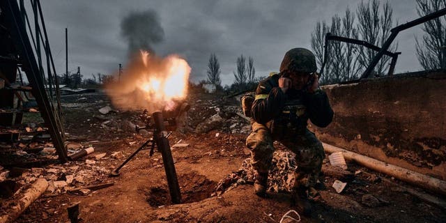 FILE - A Ukrainian soldier fires a mortar at Russian positions in Bakhmut, Donetsk region, Ukraine, Thursday, Nov. 10, 2022.  A top adviser to Ukraine's president has cited military chiefs as saying 10,000 to 13,000 Ukrainian soldiers have been killed in the country's nine-month struggle against Russia's invasion.