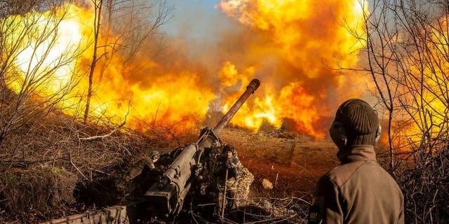 Ukrainian servicemen fire a 130 mm towed field gun M-46 on a front line, as Russia's attack on Ukraine continues, near Soledar, Donetsk region, Ukraine, in this handout image released November 10, 2022. 