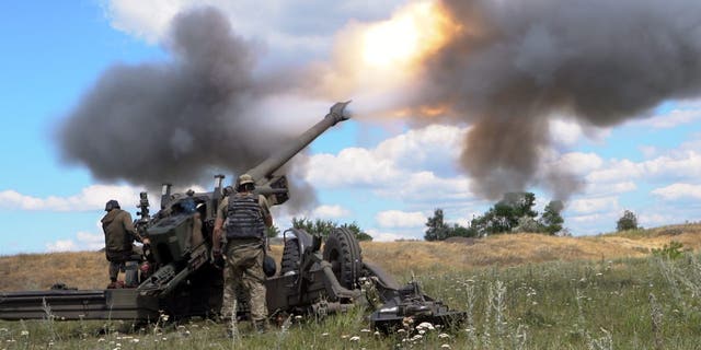 Ukrainian servicemen fire a towed howitzer in eastern Ukraine. This photo cannot be distributed in the Russian Federation. 