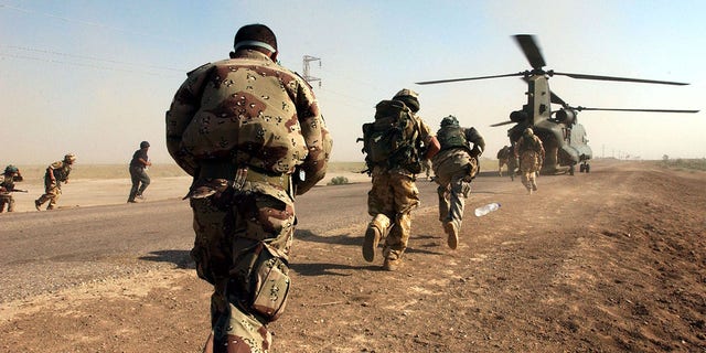 FILE: British Army soldiers, from the Royal Welch Fusiliers Regiment and Iraqi National Guards, reboard a Chinook Helicopter in southern Iraq, during their first joint Eagle Airborne Vehicle Check Point Patrol. 