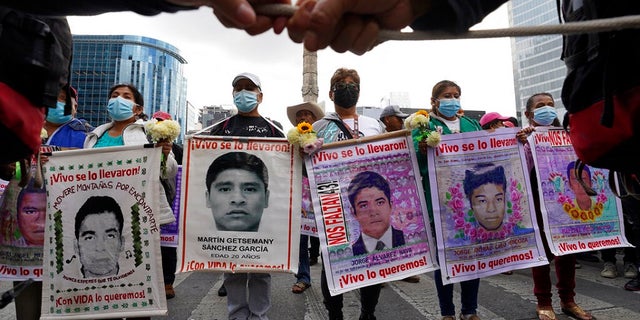 Relatives and classmates of the missing 43 Ayotzinapa college students, march in Mexico City, Sept. 26, 2022, on the anniversary of their disappearance in Iguala, Guerrero state. U.S. authorities handed over a key suspect, Alejandro Tenescalco, in the 2014 disappearances, after the man was caught trying to cross the border Dec. 20, 2022 without proper documents. 