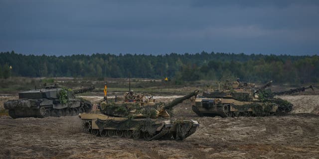The US Abrams tanks and the German Leopard seen at the training ground in Nowa Deba on September 21, 2022, in Nowa Deba, Subcarpathian Voivodeship, Poland. (Artur Widak/NurPhoto via Getty Images)