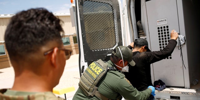 A member of the Border Patrol's Search, Trauma, and Rescue Unit (BORSTAR) observes a migrant from Central America who was detained by U.S. Customs and Border Protection (CBP) agents after crossing into the United States from Mexico, in Dona Ana County, New Mexico, U.S., July 15, 2021. REUTERS/Jose Luis Gonzalez/File Photo