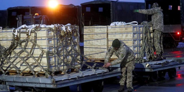 FILE PHOTO: Ukrainian service members unload a shipment of military aid, delivered as part of the United States' security assistance to Ukraine, at the Boryspil International Airport outside Kyiv, Ukraine.