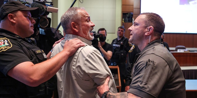 Jon Tigges is detained following a controversial Loudoun County School Board meeting which included discussion of Critical Race Theory, in Ashburn, Virginia, U.S.  June 22, 2021. 
