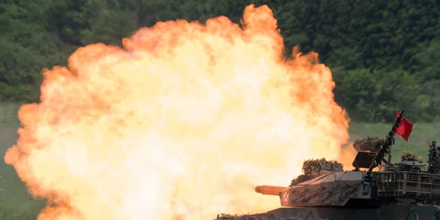A Japan Ground Self-Defense Force Type 10 battle tank fires ammunition during a live exercise at East Fuji Maneuver Area in Gotemba, Shizuoka, Japan, on May 28, 2022.