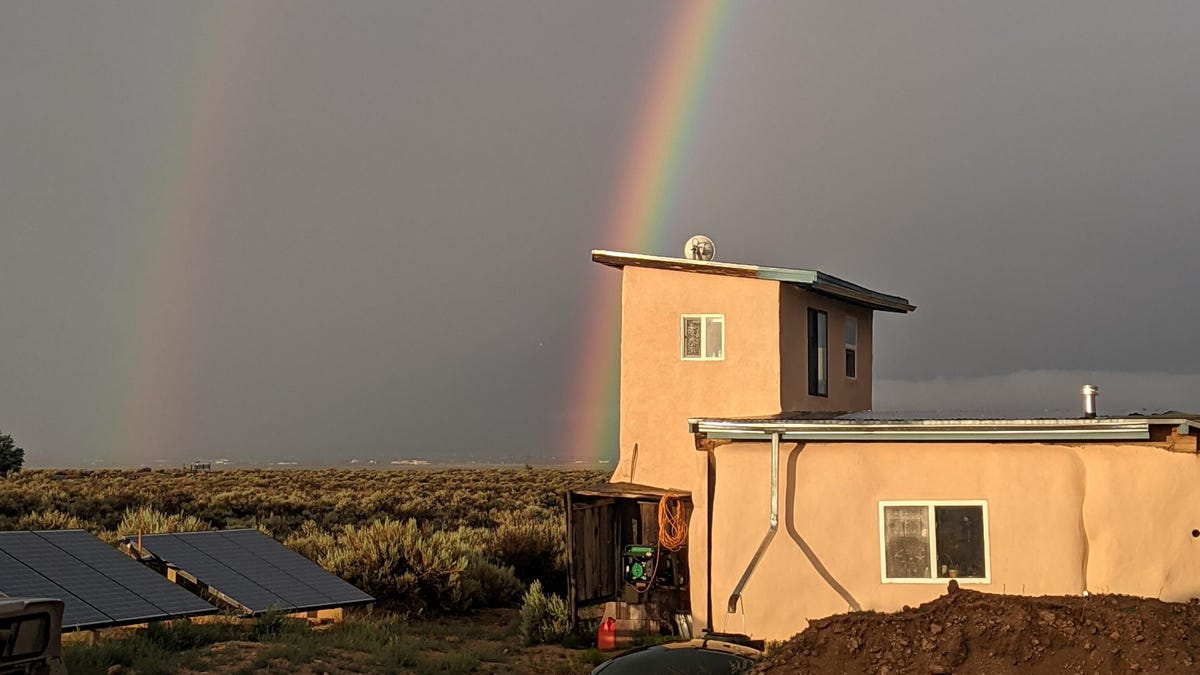 Double rainbow behind a small desert home