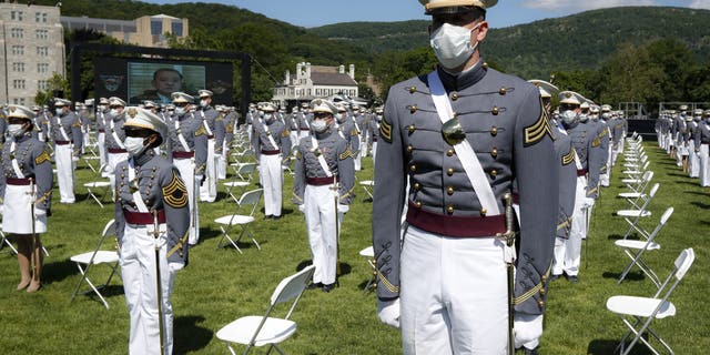 United States Military Academy graduating cadets wear face masks as they stand next to their socially-distanced seats during commencement ceremonies, Saturday, June 13, 2020, in West Point, N.Y. President Donald Trump’s commencement speech to the 1,100 graduating cadets during a global pandemic comes as arguments rage over his threat to use American troops on U.S. soil to quell protests stemming from the killing of George Floyd by a Minneapolis police officer.