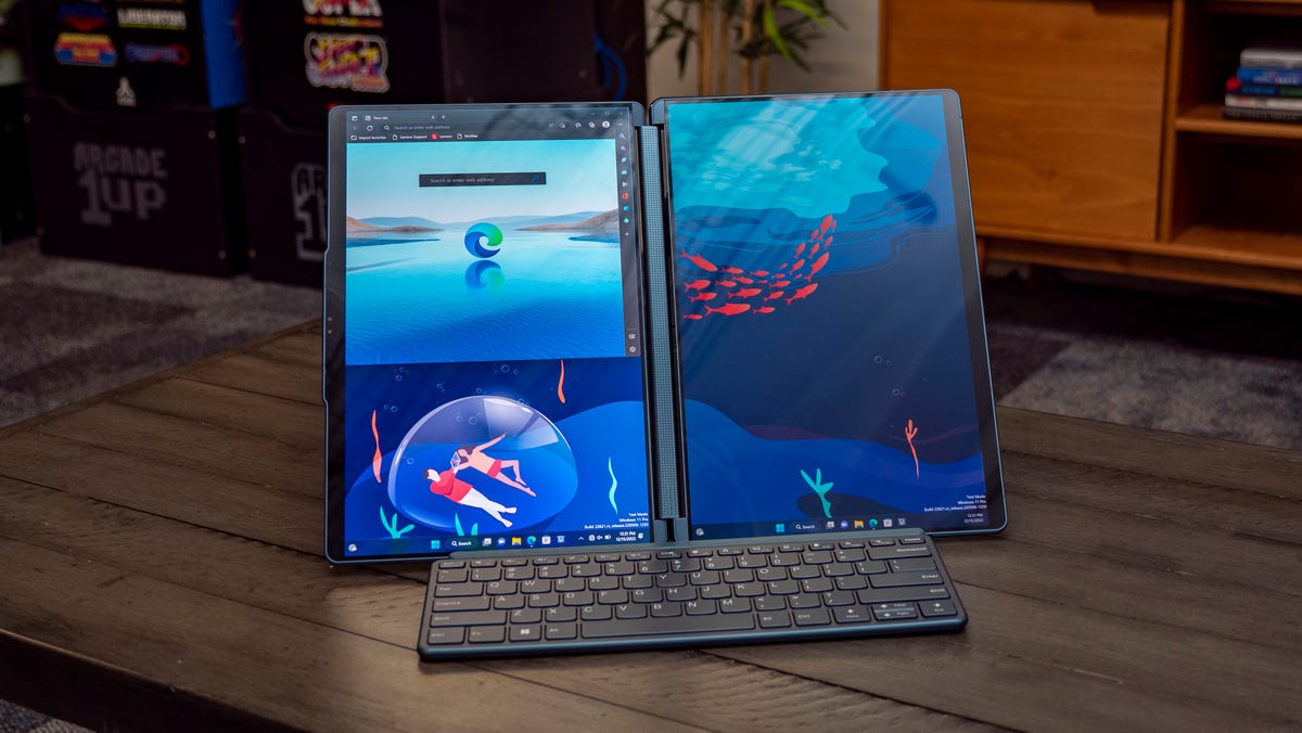 Lenovo Yoga Book 9i dual-screen laptop in landscape position with its included Bluetooth keyboard in front.