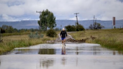 Sandes fording a river during the 16-day run around Lesotho. He says he went through a pair of socks every day.