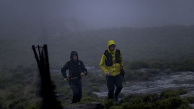 Griesel and Sandes making a big push up one of Lesotho's many mountains during a particularly rainy day.