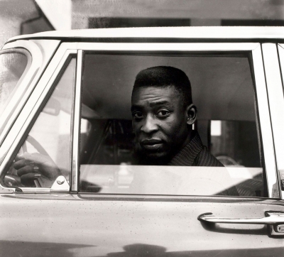 Pelé sits behind the wheel of his car in 1961. He grew up poor in Bauru, Brazil, and honed his craft playing barefoot with improvised balls made of coconuts or balls of socks.