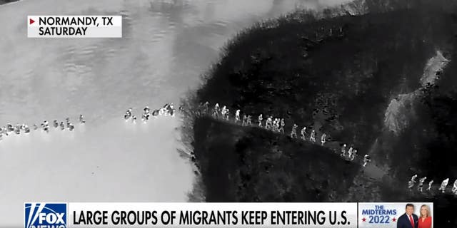 Migrants cross the US-Mexico border. (Fox News)