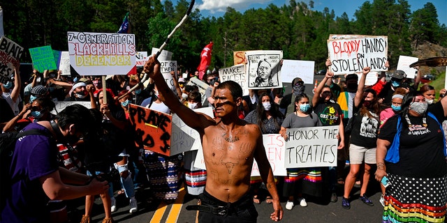 Activists and members of different tribes from the region block the road to Mount Rushmore National Monument as they protest in Keystone, South Dakota, on July 3, 2020, during the visit of former President Donald Trump. 