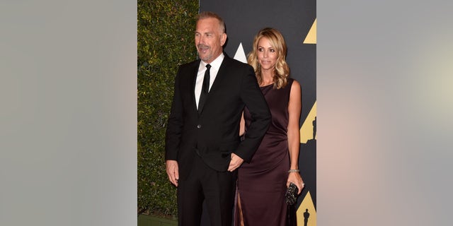 Kevin Costner and Christine Baumgartner attend the 2014 Governors Awards at the Ray Dolby Ballroom in Hollywood, California.