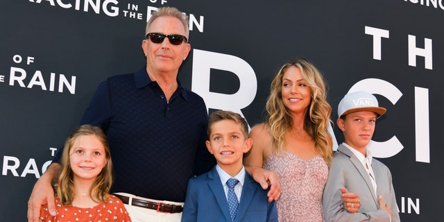 Kevin Costner and wife Christine Baumgartner pose with their three children.